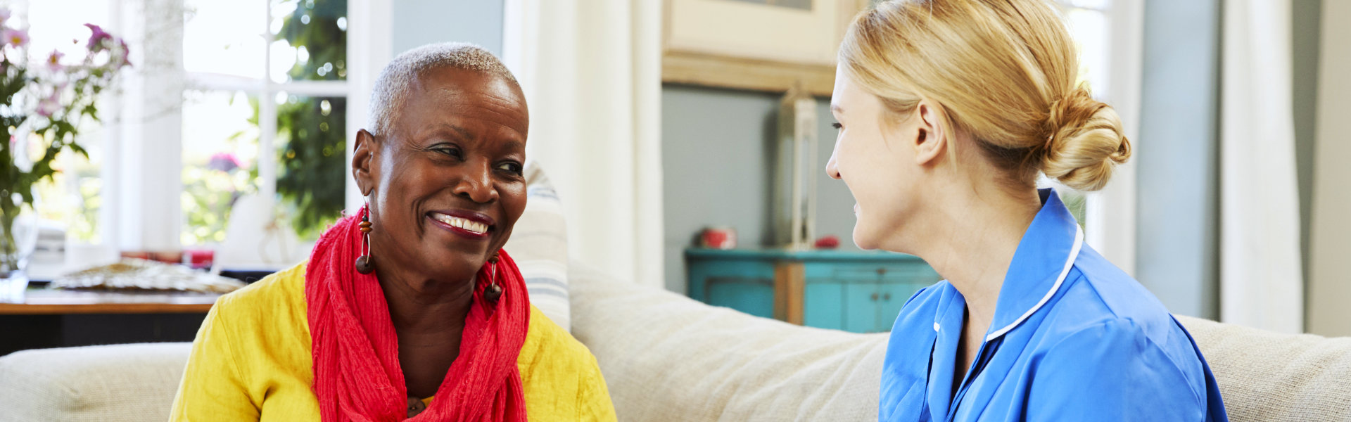 nurse and elderly woman smiling at each other