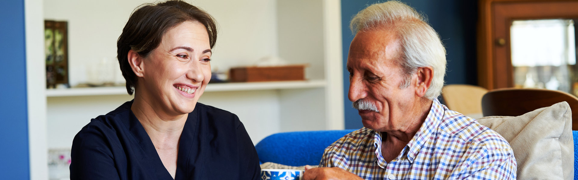 aide and elderly man smiling