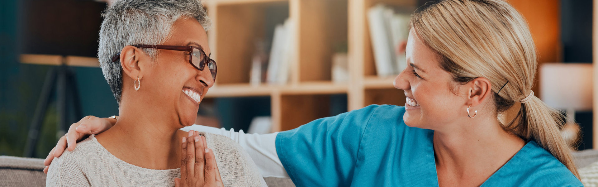 nurse and elderly woman smiling at each other